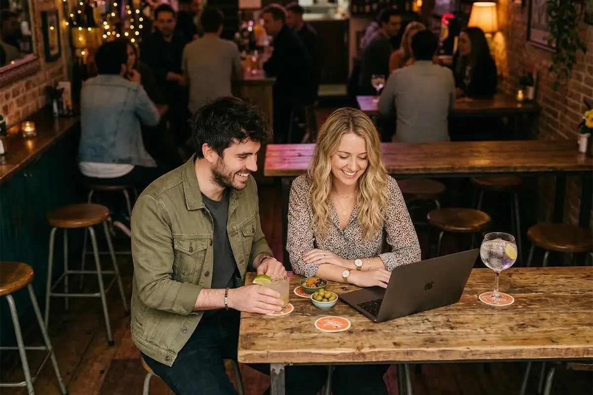 Happy restaurant owner reviewing website